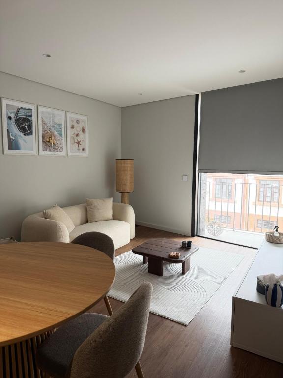 a living room with a couch and a table at Premium T1 - Blue Ocean in Espinho
