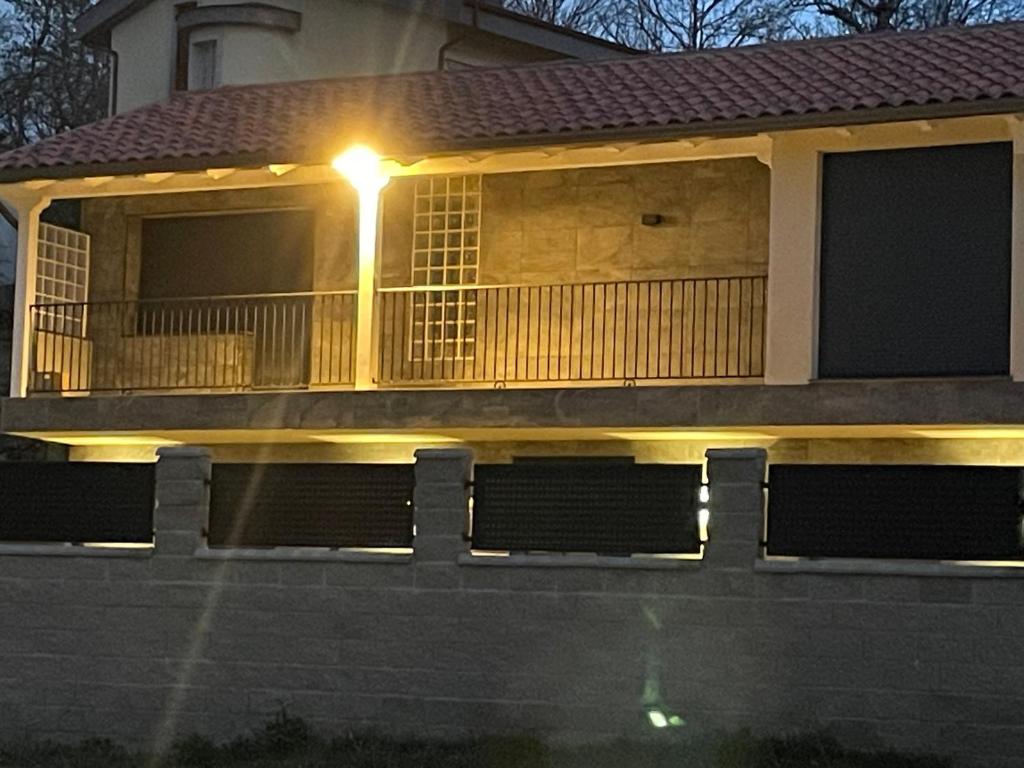 a house with a balcony with a light on it at Casa Los Tres Panetes Béjar in Béjar