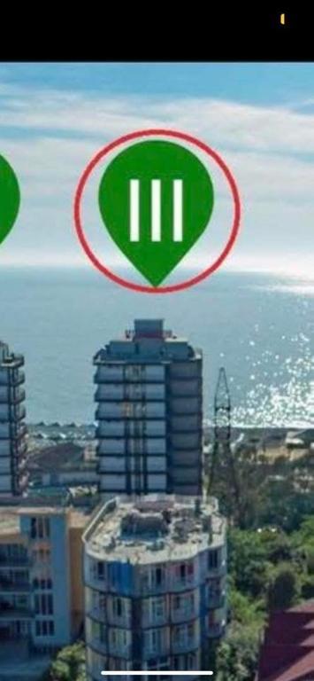 a sign on top of a building in front of the ocean at GONIO Mgzavrebi III Apartment 403 in Gonio