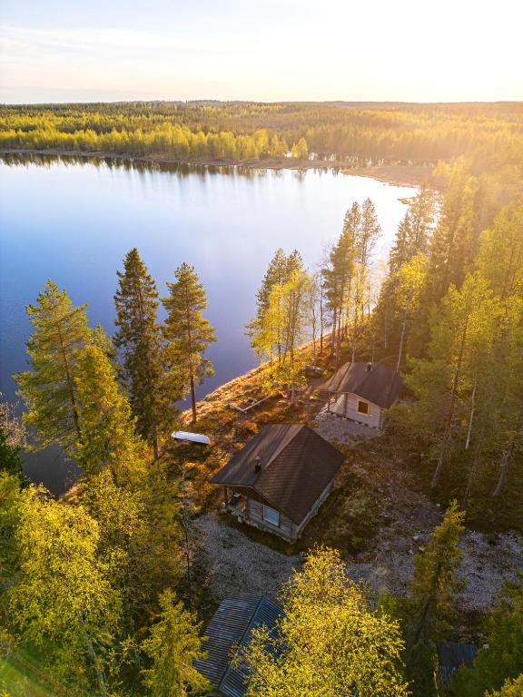 an aerial view of a lake with two cottages at Kutulammen erämökki saunalla in Ranua