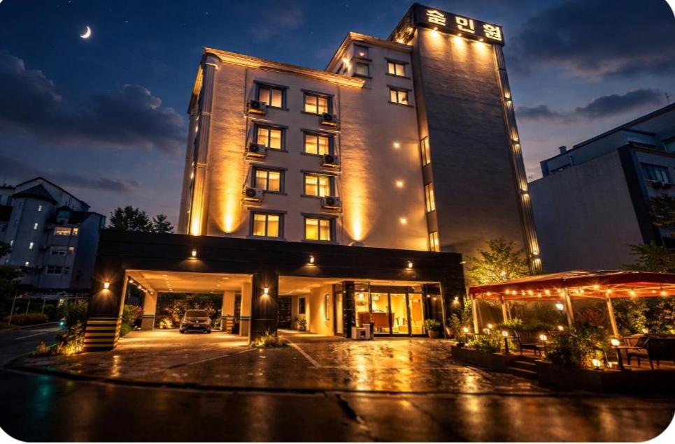 a tall building with lights on top of it at Hole in One Hotel in Chuncheon