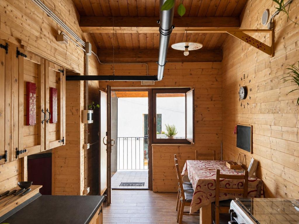 a kitchen and dining room with a table and a window at Le scalette di Giocondo in Roio Piano