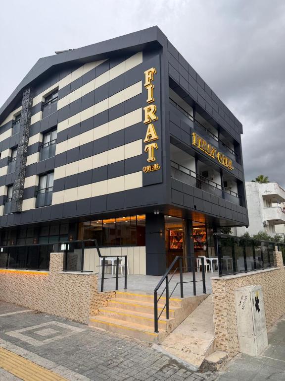 a black building with a hotel sign on it at Fırat Otel in Marmaris