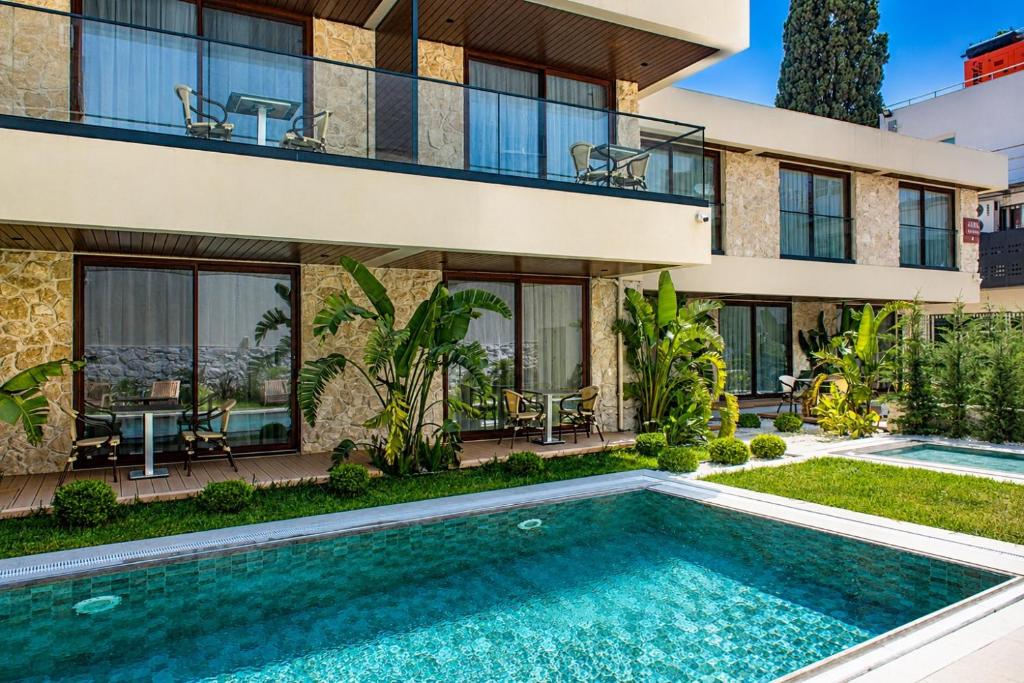 an exterior view of a house with a swimming pool at Arkk Rooms in Antalya