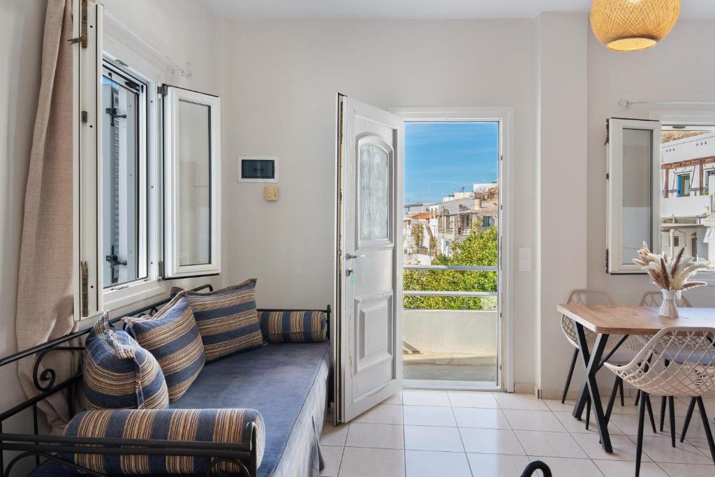 a living room with a couch and a table at Driopida 5 Irida Kythnos in Mérikhas