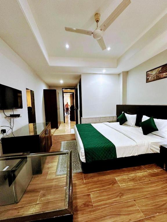 a hotel room with a bed and a tv at VRResidency in Gurgaon