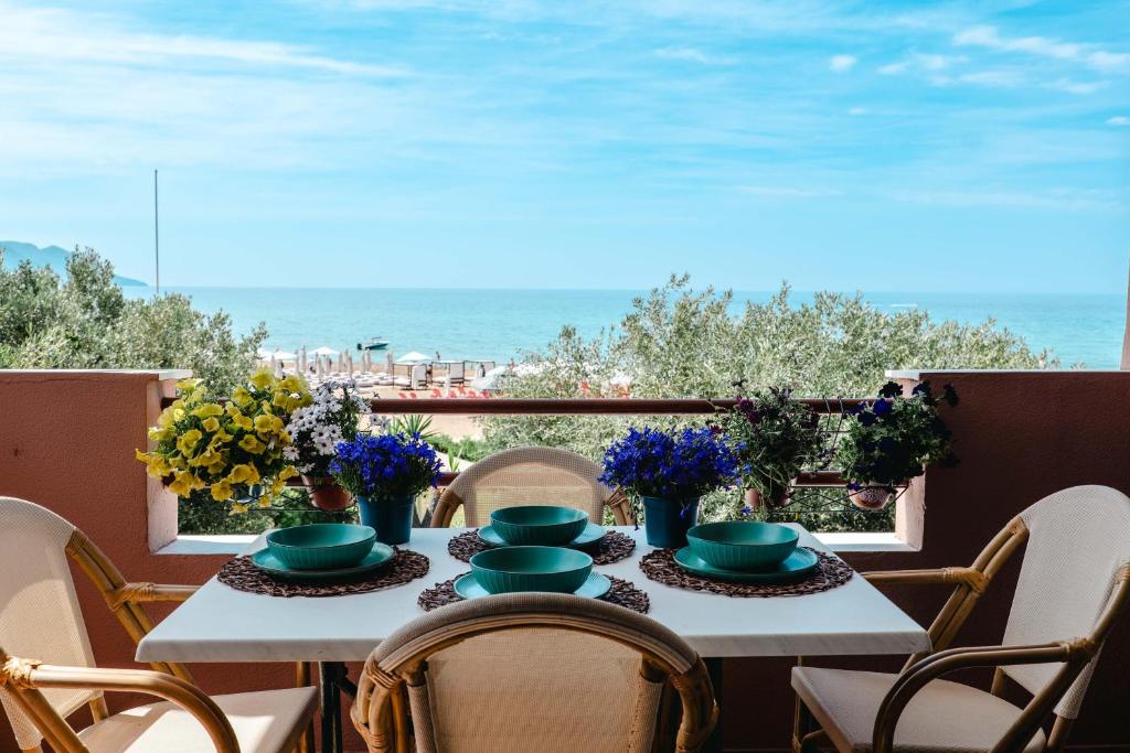 a table with a view of the beach and the ocean at Corfu Glyfada Beach Apartment 58a in Corfu