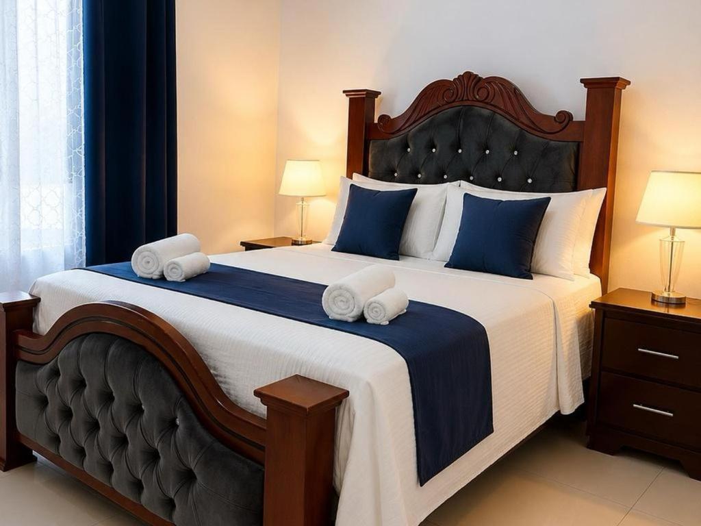 a bedroom with a large bed with two towels on it at Modern Cozy apartment in Boca Chica