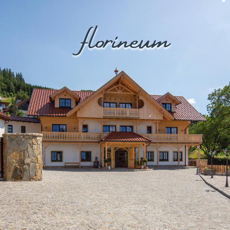a large wooden building with a roof at Florineum in Weyregg