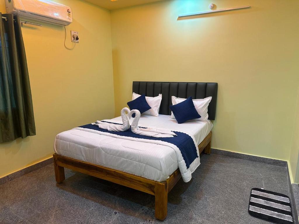 a bedroom with a bed with two towels on it at wonderful stays in Tirupati