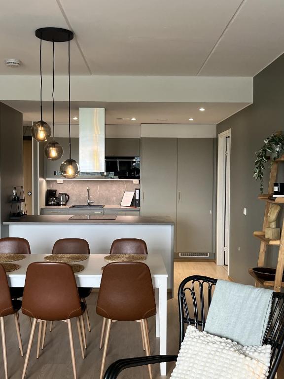 a kitchen and dining room with a table and chairs at Tikka Apartments in Jyväskylä