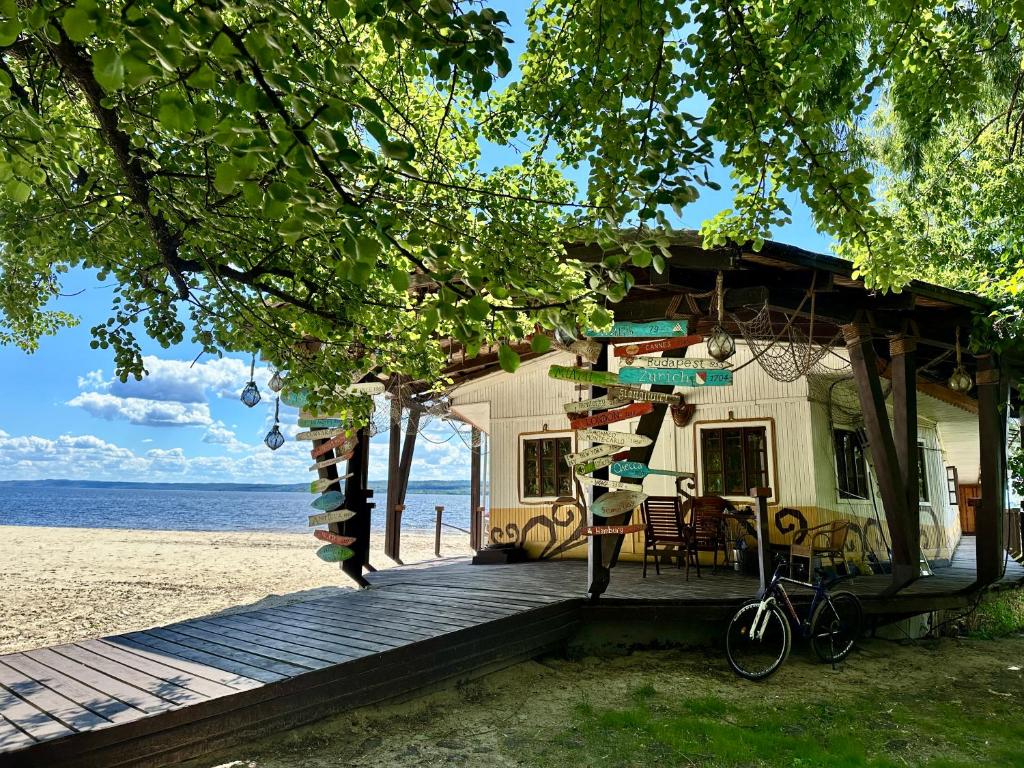 a house on the beach next to the ocean at Secret River Rooms in Pereiaslav-Khmelnytskyi