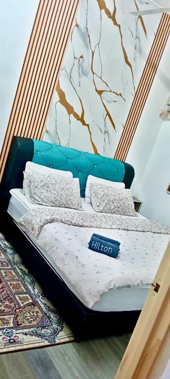 a bed in a room with a wall at Shayus Homestay in Kampong Alor