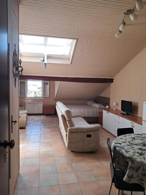 a living room with a couch and a window at Corso Garibaldi mansarda in Sanremo