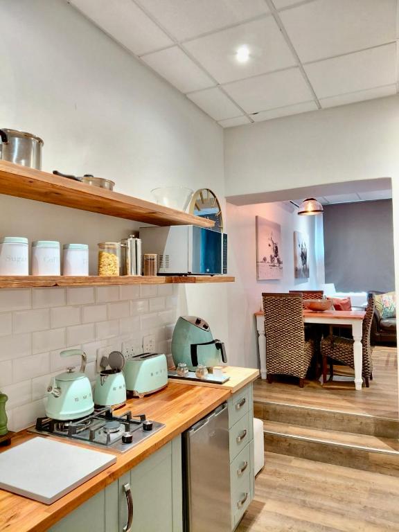 a kitchen with a counter with a stove top oven at The Stetson - Paarl - Self Catering Apartment in Paarl