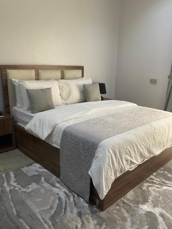 a bedroom with two beds with white sheets and pillows at Roseann Gold Boutique Hotel in Kusafe