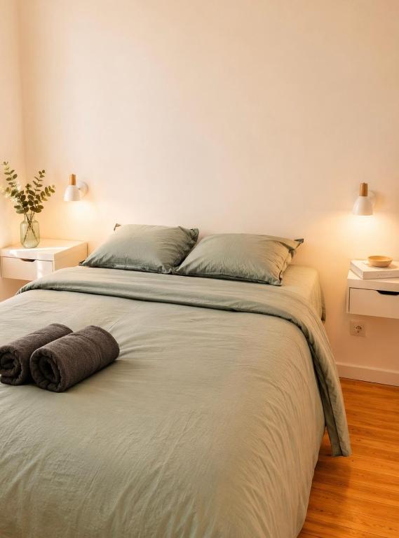 a bedroom with a large white bed with two pillows at Petite rivière in Nantes