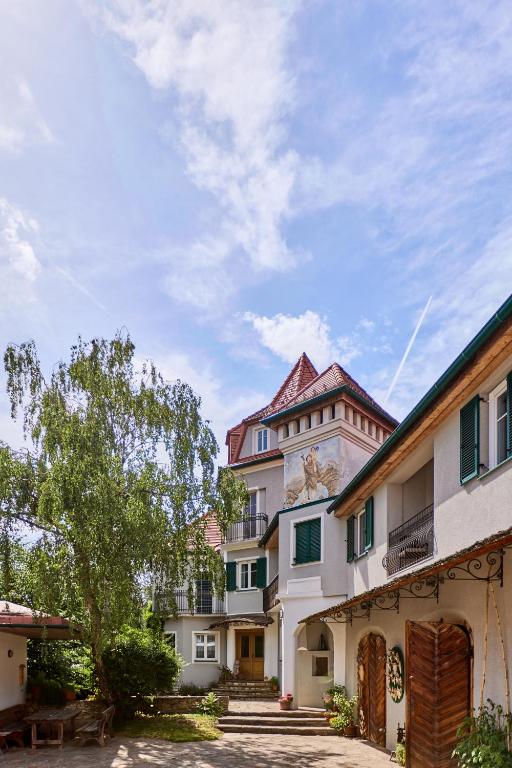 a large building with a tree in front of it at Apartment im Schlössl in Leibnitz