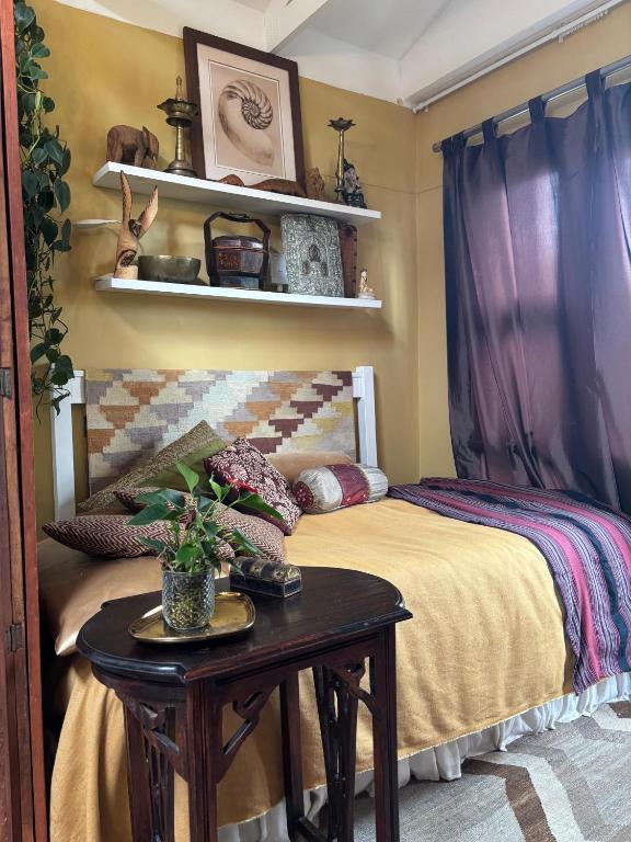 a bedroom with a bed with a table and shelves at Eagles Nest in Kirstenhof