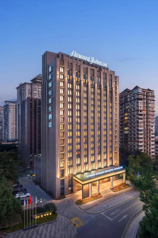a large building with a sign on top of it at Howard Johnson Jinyi Hotel Chongqing in Chongqing