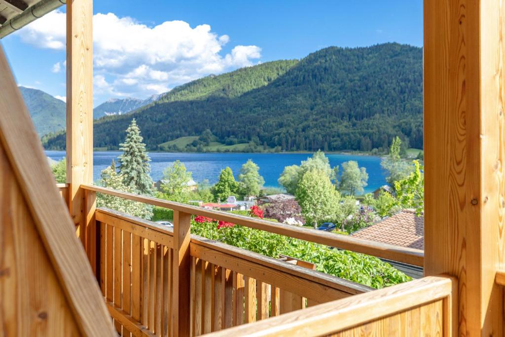 a view from the deck of a cabin overlooking a lake at Appartement Lackner TOP 2 - Weissensee in Weissensee