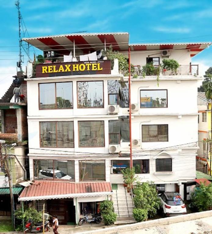 a hotel with a sign that reads relax hotel at Relax Hotel in Bāghdogra