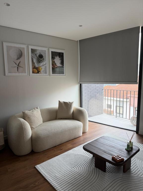a living room with a couch and a table at Premium T1 - Golden Sunset in Espinho