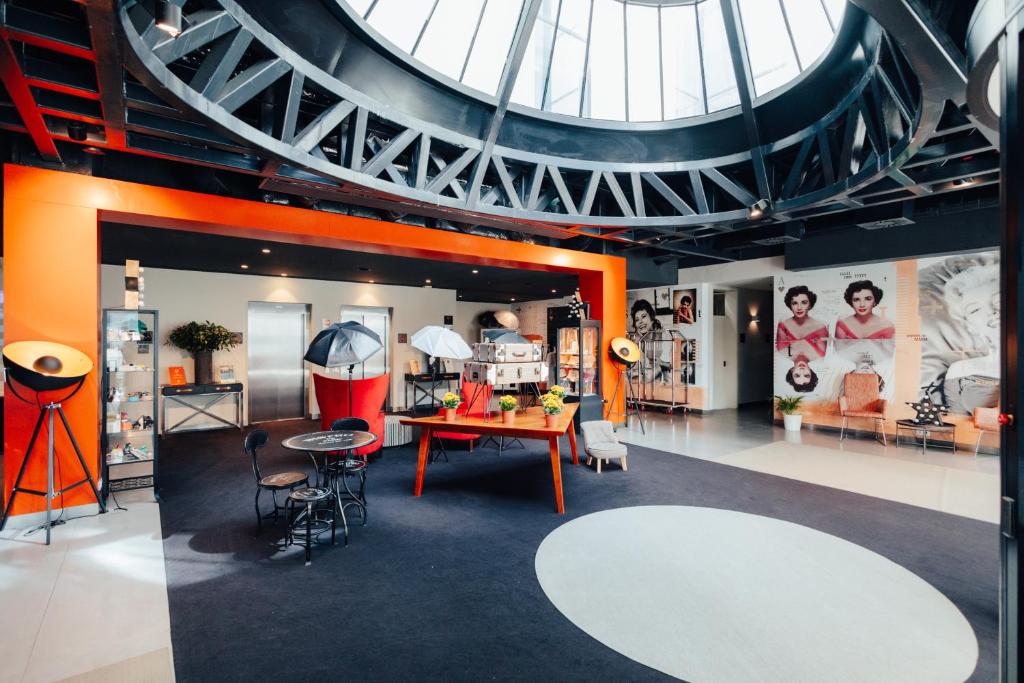 A spacious, vividly styled lobby beneath a large circular skylight.
