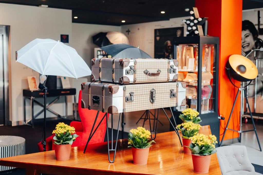 A lobby display of stacked vintage-style suitcases on a table.