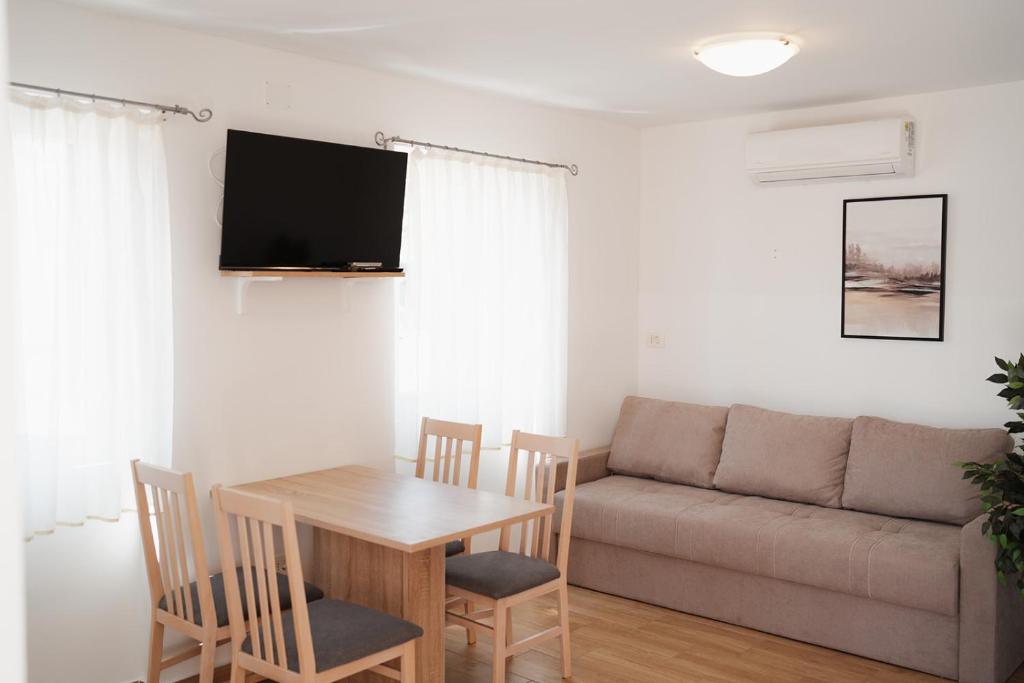a living room with a table and a couch at EUCALYPTUS in Nerezine