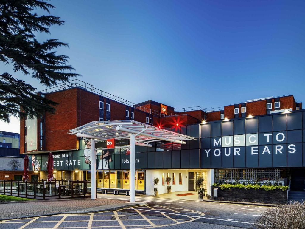 a music to your ears sign on the side of a building at ibis London Heathrow Airport in Hillingdon
