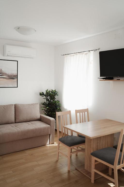 a living room with a table and a couch at LAVANDLA in Nerezine