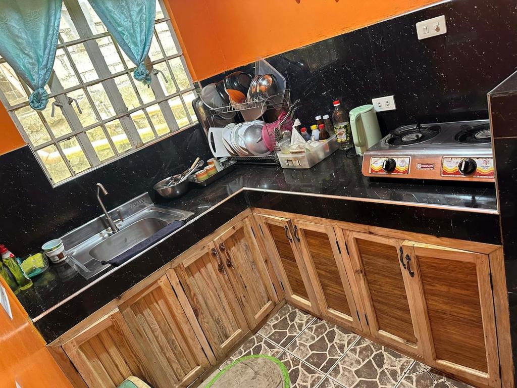 a kitchen with a sink and a counter top at Sagada Pinewood Lodge basement in Sagada