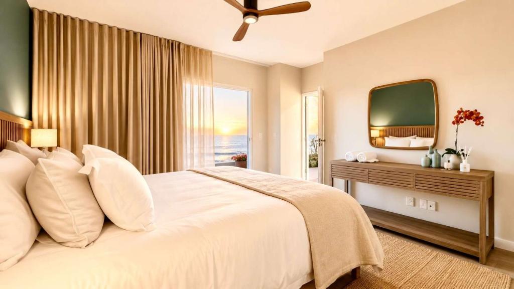 a bedroom with a large white bed and a television at 2 at Sunset View in Langstrand