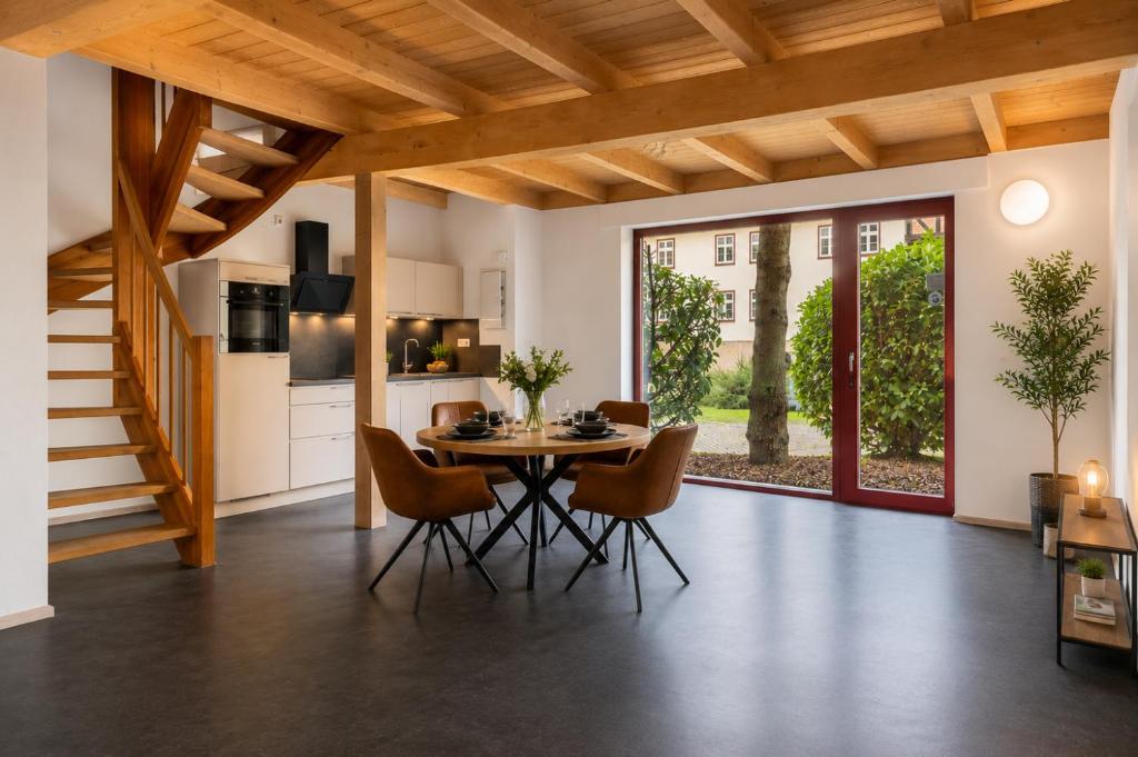 a kitchen and dining room with a table and chairs at Elementa City Lodge Quedlinburg 1 in Quedlinburg