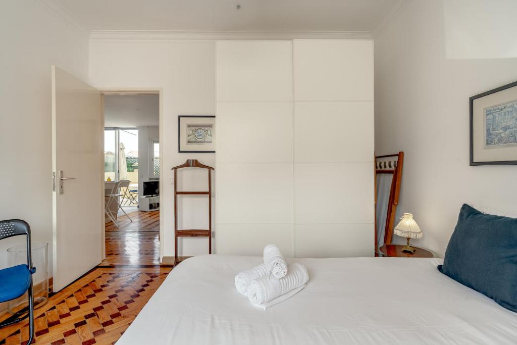 a bedroom with a white bed and a ladder at Santarem Terrace by Homing in Santarém