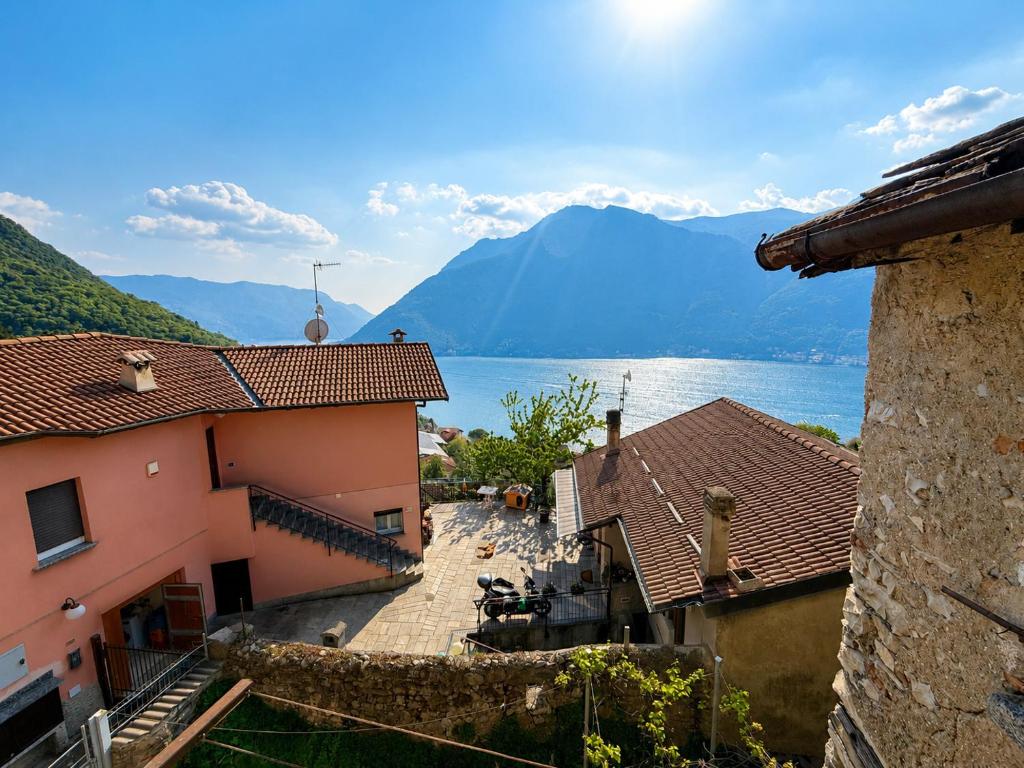 a view of a town with a lake and mountains at Panorama Lake Relax in Nesso