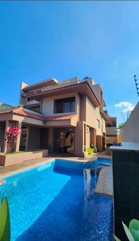 a house with a swimming pool in front of a house at ORO - Boutique Guesthouse in Matola