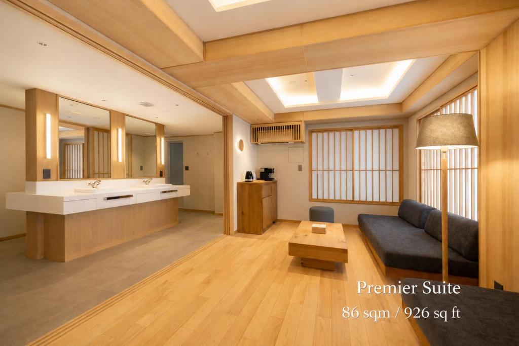 a living room with a couch and a sink at soyo-ka kyoto sanjo in Kyoto