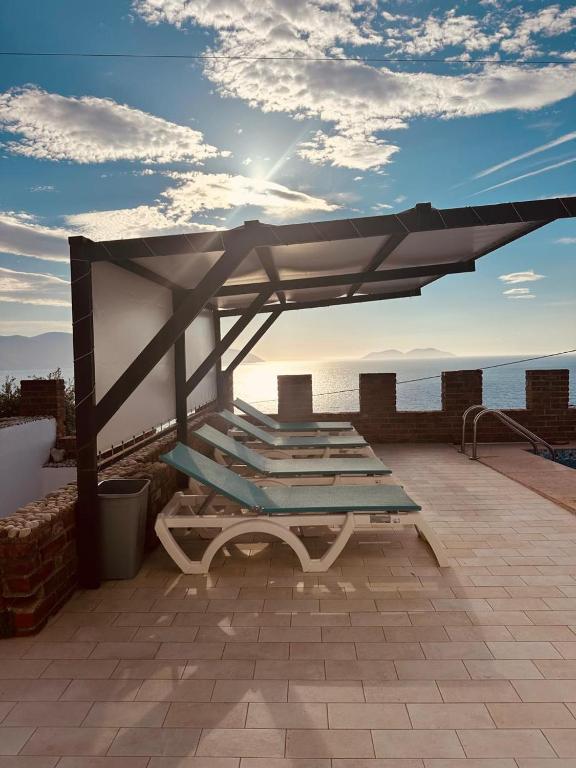 a group of benches sitting on top of a roof at Vila Rexhepaj in Vlorë