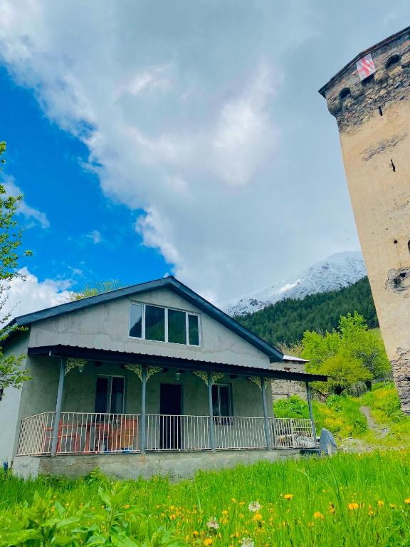 a house on a hill with a smoke stack at Zhorzholiani House - Betkili in Lakhiri