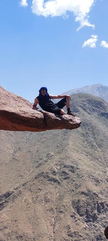 a person laying on top of a mountain at Auberge amazrane in Matat