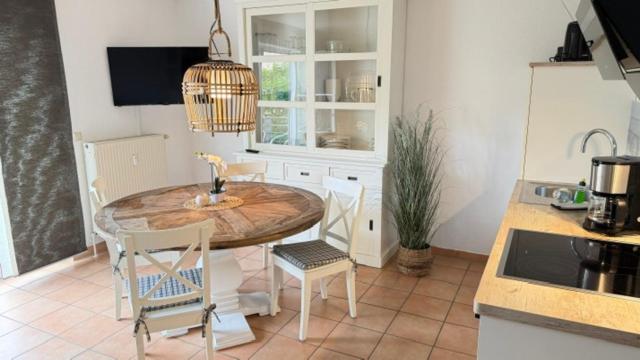 a kitchen with a table and chairs in a room at Haus Katharina, Balkon mit Meerblick in Lauterbach