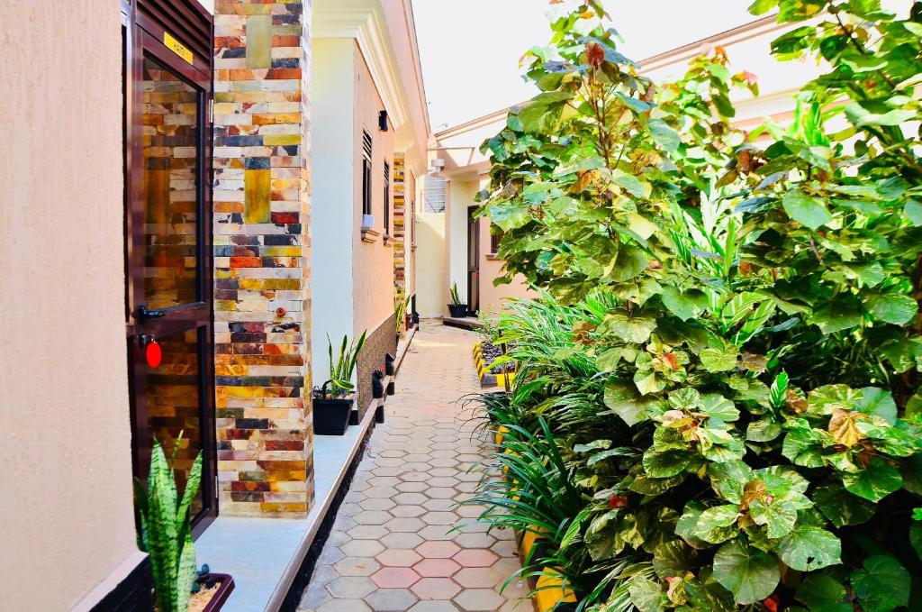 a hallway with plants on the side of a building at Townside Suites in Kyebando