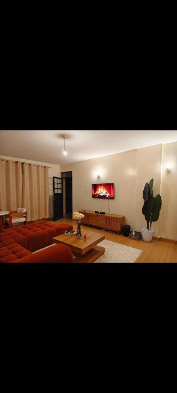 a living room with a couch and a table at Shekhy Homes in Machakos