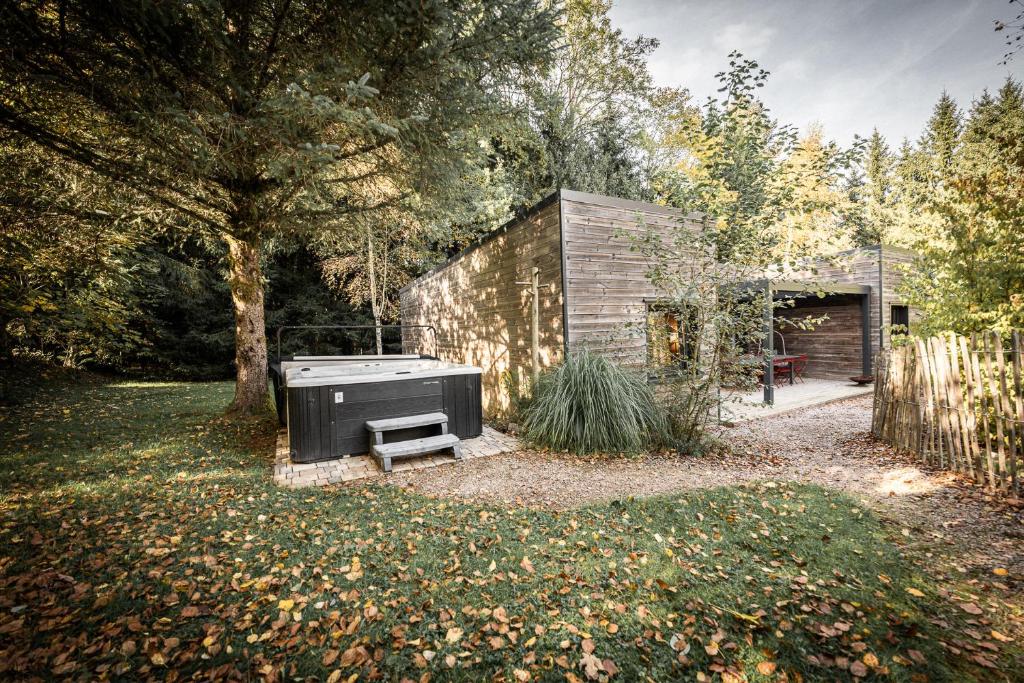 a house with a stove in a yard at chalets 4 - les jolis chalets in Barbey-Séroux