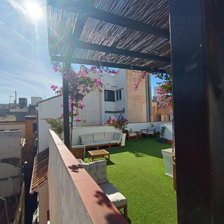 a view of a patio with a couch on a roof at Apartamentos ATARAZANAS in Málaga