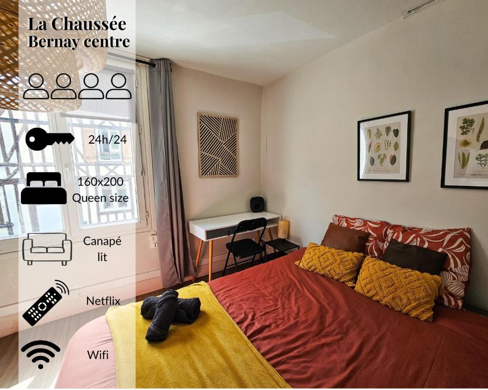 a bedroom with a bed and a desk in it at La Chaussee in Bernay