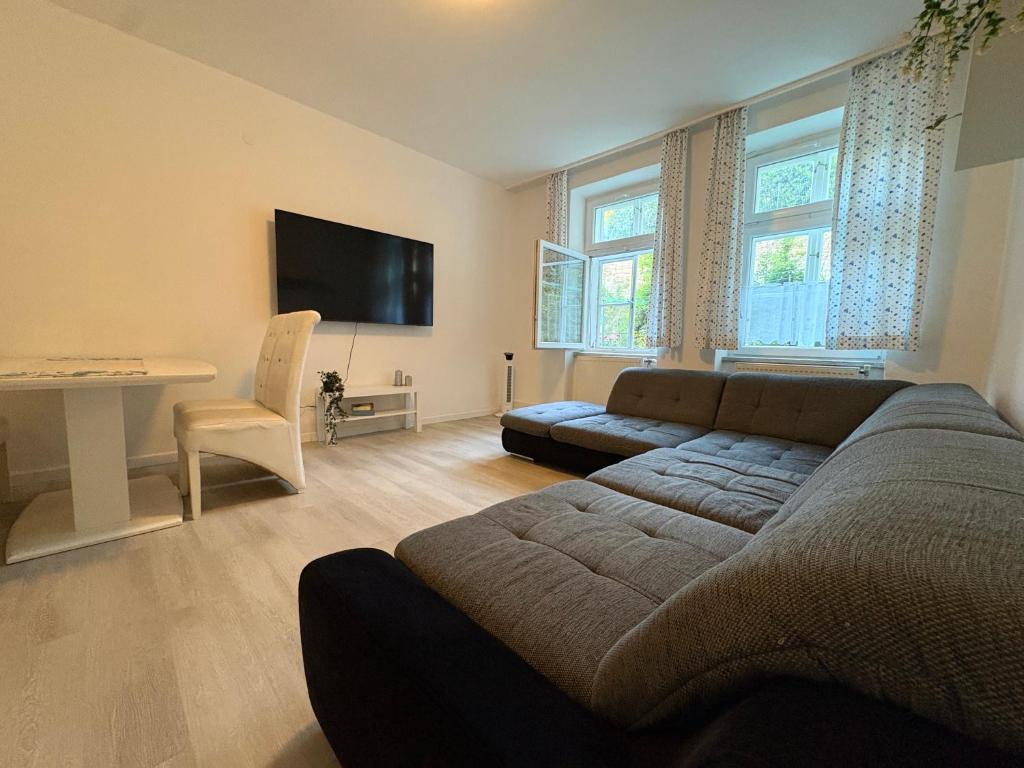 a living room with a couch and a table at Modern Apartment Melk - Altstadt & Parkplatz in Melk