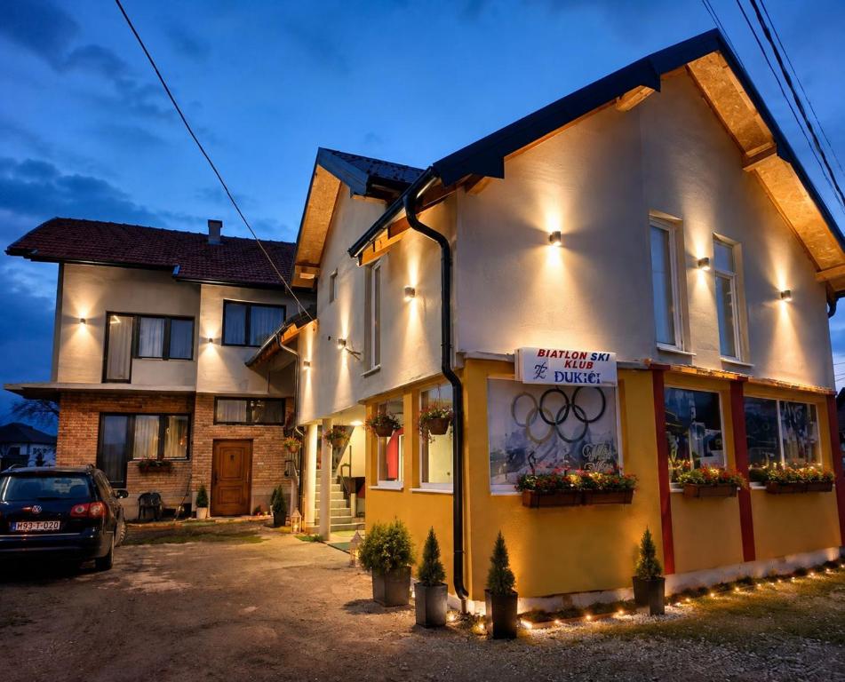 a building with a sign on the side of it at Apartmani Hena in Sjenica